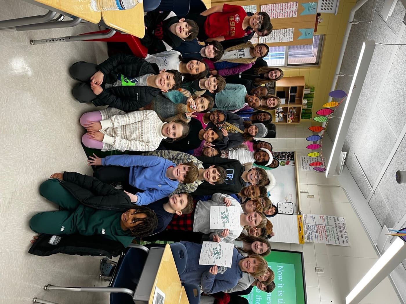 4 Green Futures mentors and elementary school students celebrating together after a lesson