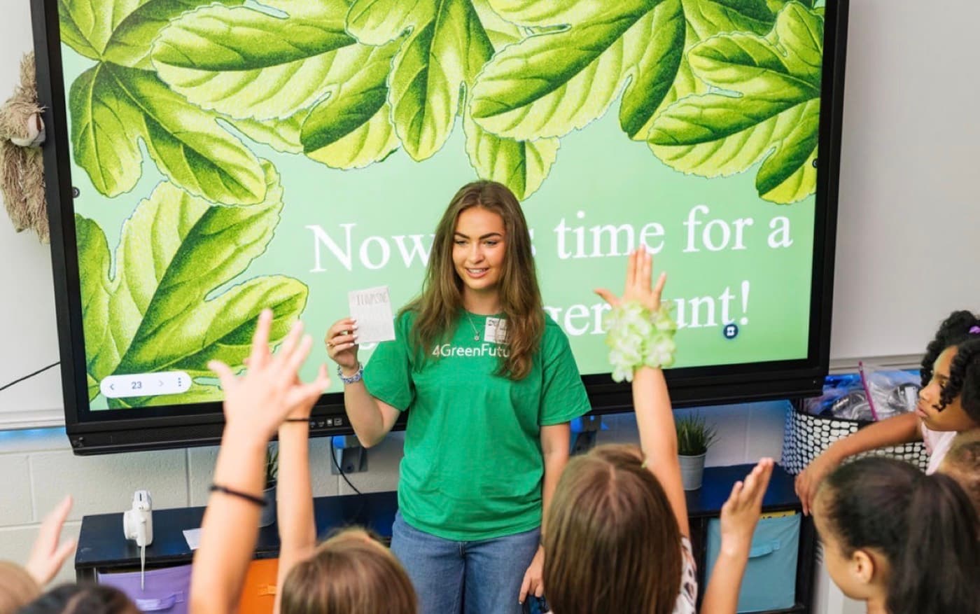 A 4 Green Futures mentor leading a scavenger hunt activity with elementary students