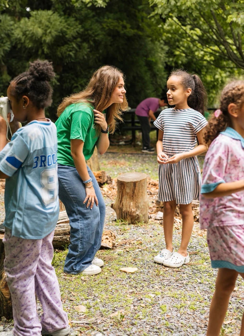 A 4 Green Futures mentor talking with an elementary student outdoors
